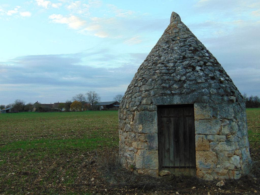 Loge restaurée de la Mitaudière. Les pierres ont été jointoyées au ciment. La ferme de la Mitaudière en arrière plan.