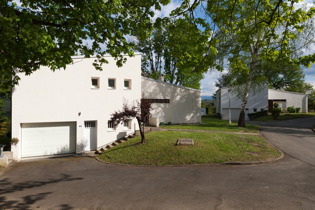 Façade avec garage et cheminement autour des maisons