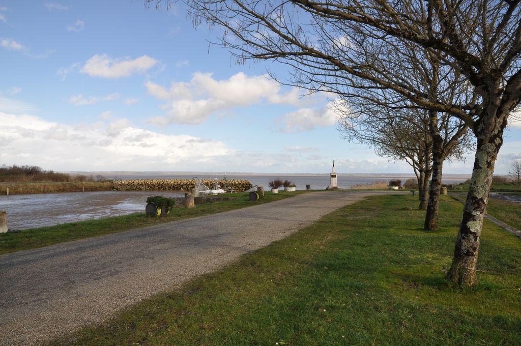 Chenal, rive sud : quai avec croix commémorative.