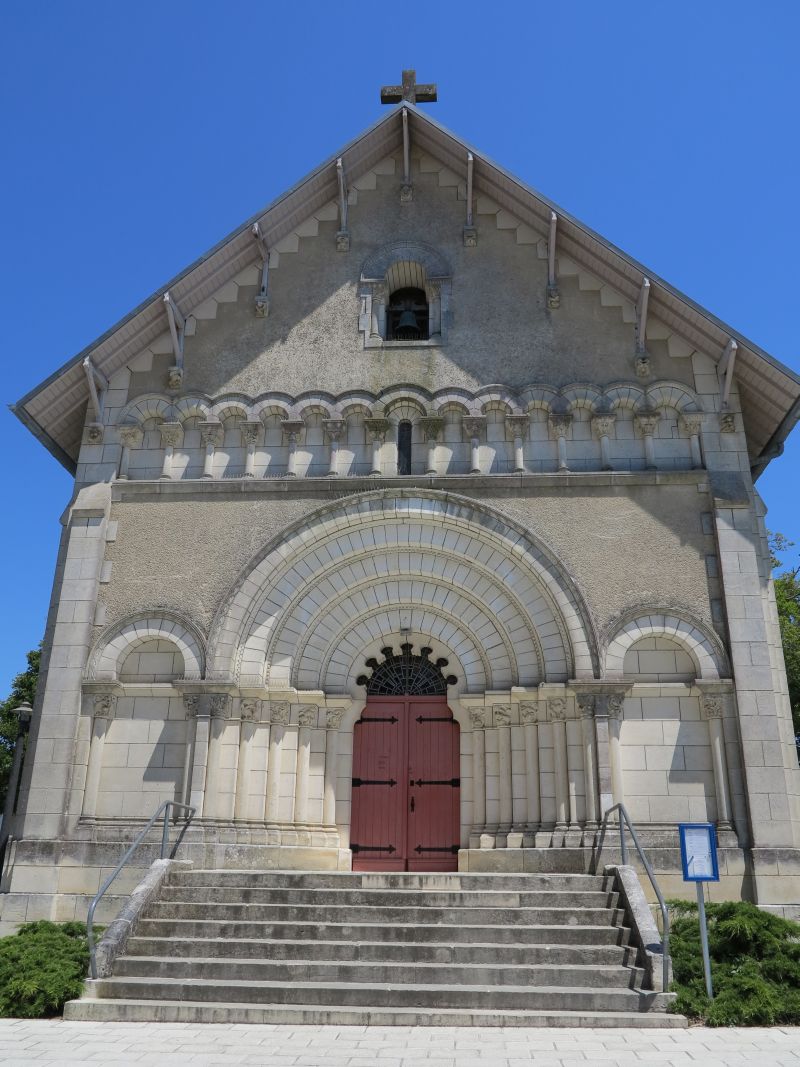 La façade occidentale et son décor néo-roman, sous un large débordement de toit.